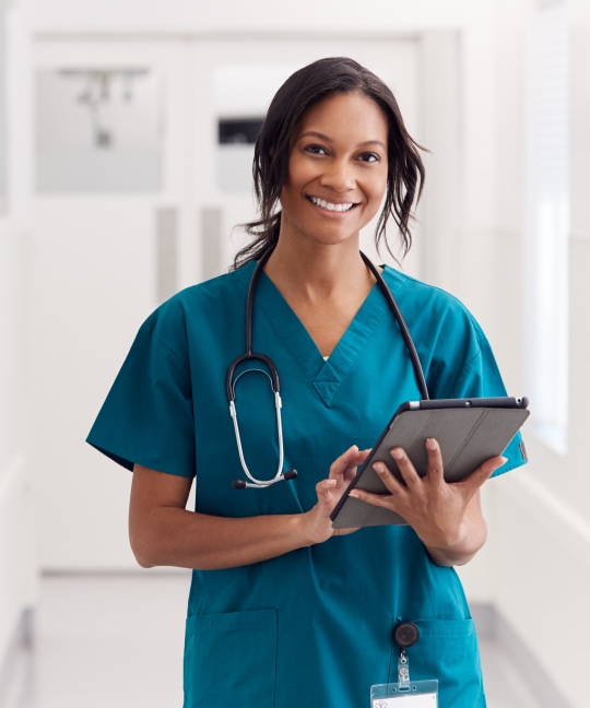 a person in scrubs holding a tablet