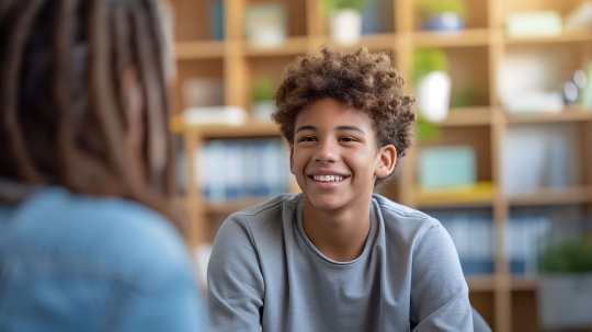 a child smiling at a person