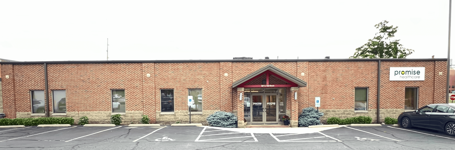 a brick building with a parking lot